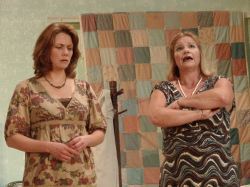 Lenny Magrath (Cynthia Huesman) and Cousin Chick (Mary Fettes) discuss family problems