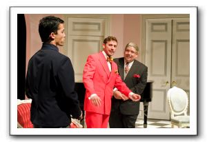 Jacob Yeh, left, and Lucas Beck, center, as master and servant who have switched places, with their host, Jon Johnson