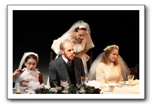 Kelley Slagle, center, argues with Ryan Tumulty at the wedding feast; Sydney Maloney sits at Tumulty's left, with Emily Hemmingson at his right.