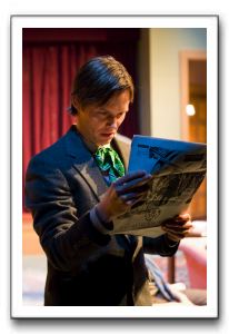 There's bloody murder in the newspaper, as Karl Bittner, playing Christopher Wren, discovers.