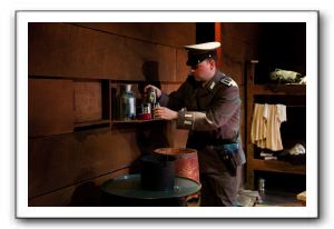 Shultz (Hans Dettmar) looks for a clue