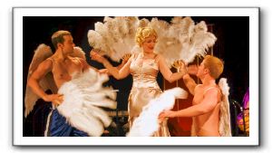 Mae (Rachel Hardin) with musclemen angels (Shannon Perkins Jr., and Johnno Wilson)