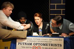 Spelling Bee contestant William Barfee (played by Alden Michels) shows school officials his 'magic foot.' Also pictured are Carl Williams, Kathleen Richards, and Jason Damaso.