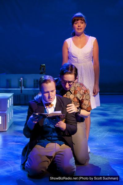 Billy Argo (Stephen Gregory Smith) looks through an old diary as crime partners Fenton (James Gardiner) and Caroline (Margo Seibert) look on.