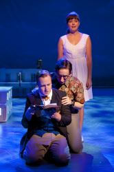 Billy Argo (Stephen Gregory Smith) looks through an old diary as crime partners Fenton (James Gardiner) and Caroline (Margo Seibert) look on.