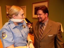Rookie cop Billie Dwyer (Elsbeth Clay) is threatened by mob hitman Todd (Jim Adams) during the motel room police sting.