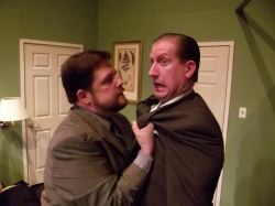 Mob hit man Todd (Jim Adams) and Agent Frank (Eric Small) security guard for the Mayor have a tense moment.
