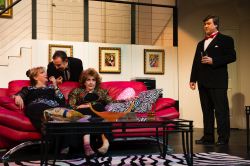 Claire Ganz (Jina Ames) and Chris Gorman (Ruth Neaveill) gossip rumors while Lenny Ganz (Chuck Dluhy) and Ken Gorman (Tom Flatt) listen in disbelief.