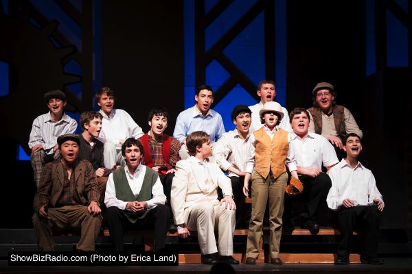 Father (Christopher Walkup, center in White) takes his son Edgar (Olivia Speck, standing) to a baseball game and is shocked by the language and coarse behavior he observes