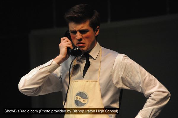 Bud Frump (Rolf Lundberg) takes a phone call in the mailroom of World Wide Wickets