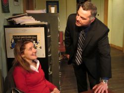 New theater intern Heidi Bishop (Emily Sucher) fends off the advances of business manager Mike Braschi (Chris Hawkins)
