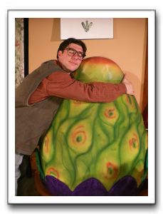 Ryan Schaffer as Seymour Krelborn and Audrey II, as voiced by Antonio Bullock and puppeteered by George Rouse